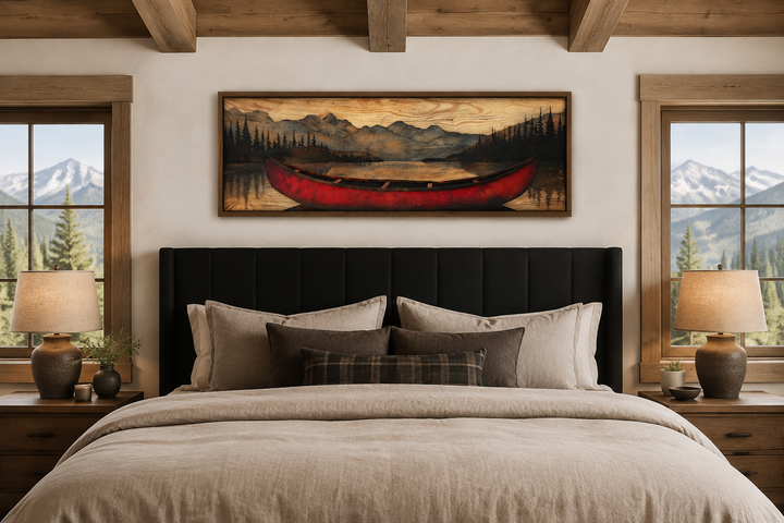 Old red canoe painted on wood long horizontal framed canvas wall art hanging above a bed.