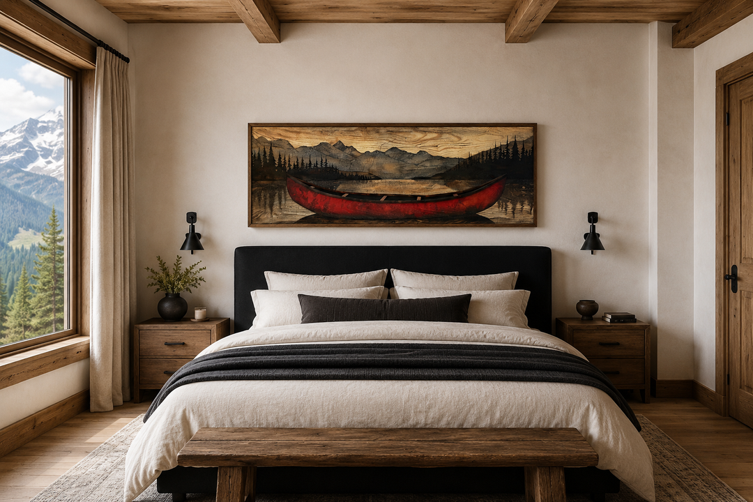 Old red canoe painted on wood long horizontal framed canvas wall art above a bed in a rustic room.