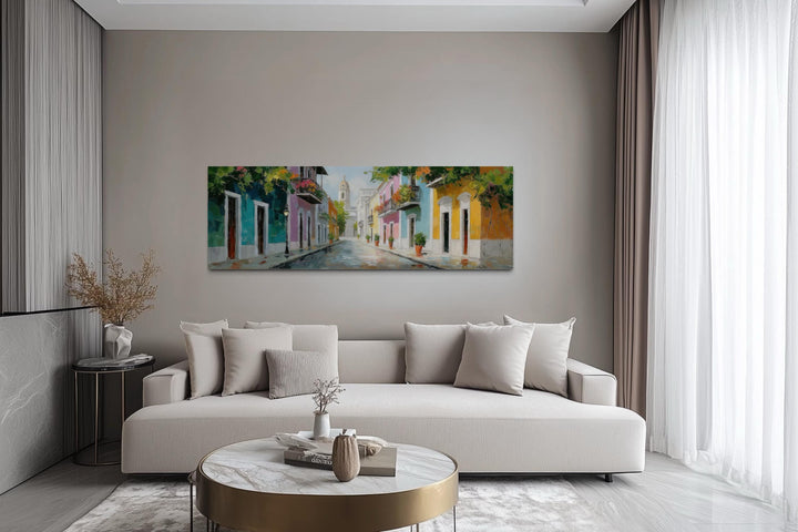 Old San Juan Street Puerto Rico long horizontal wall art above a modern sofa in a living room.