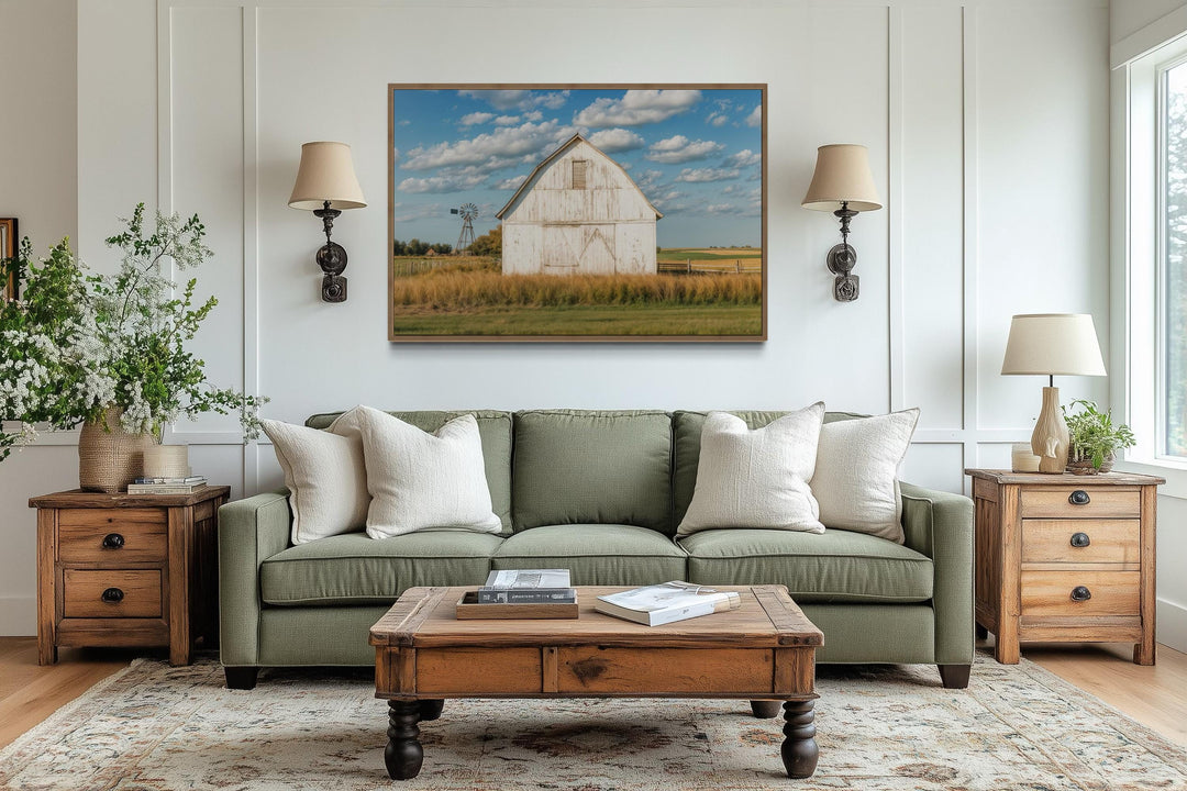 Old weathered white barn with windmill framed canvas wall art in a farmhouse living room.