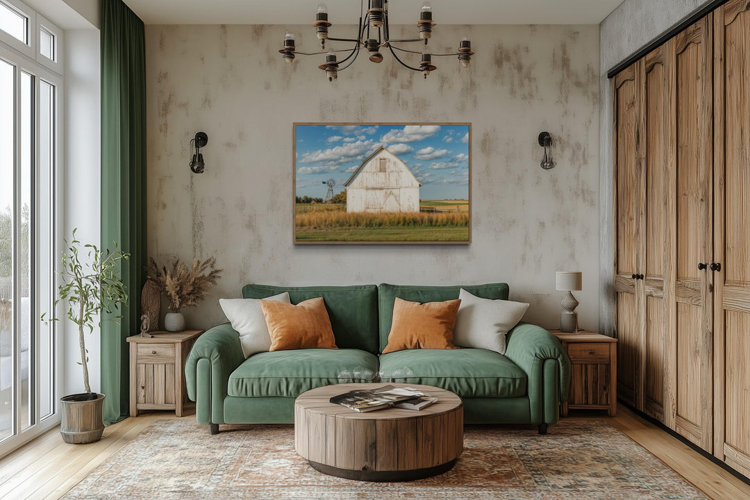 Old weathered white barn with windmill framed canvas wall art in a farmhouse living room.