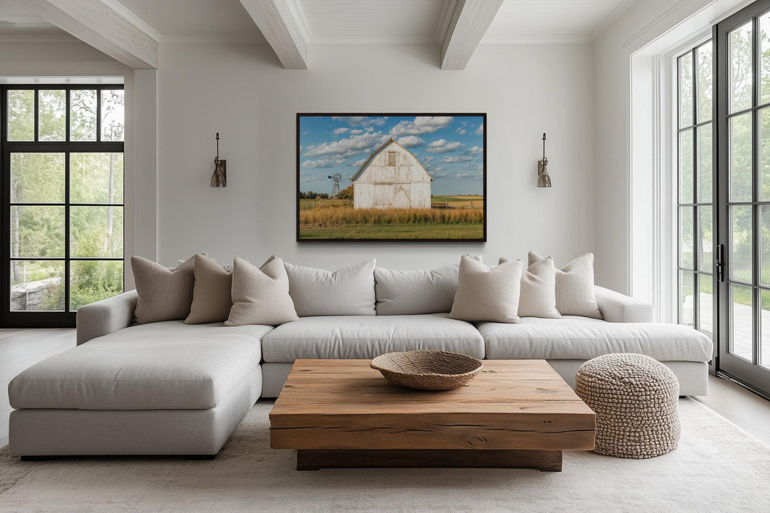 Old weathered white barn and windmill framed canvas wall art in a farmhouse living room.