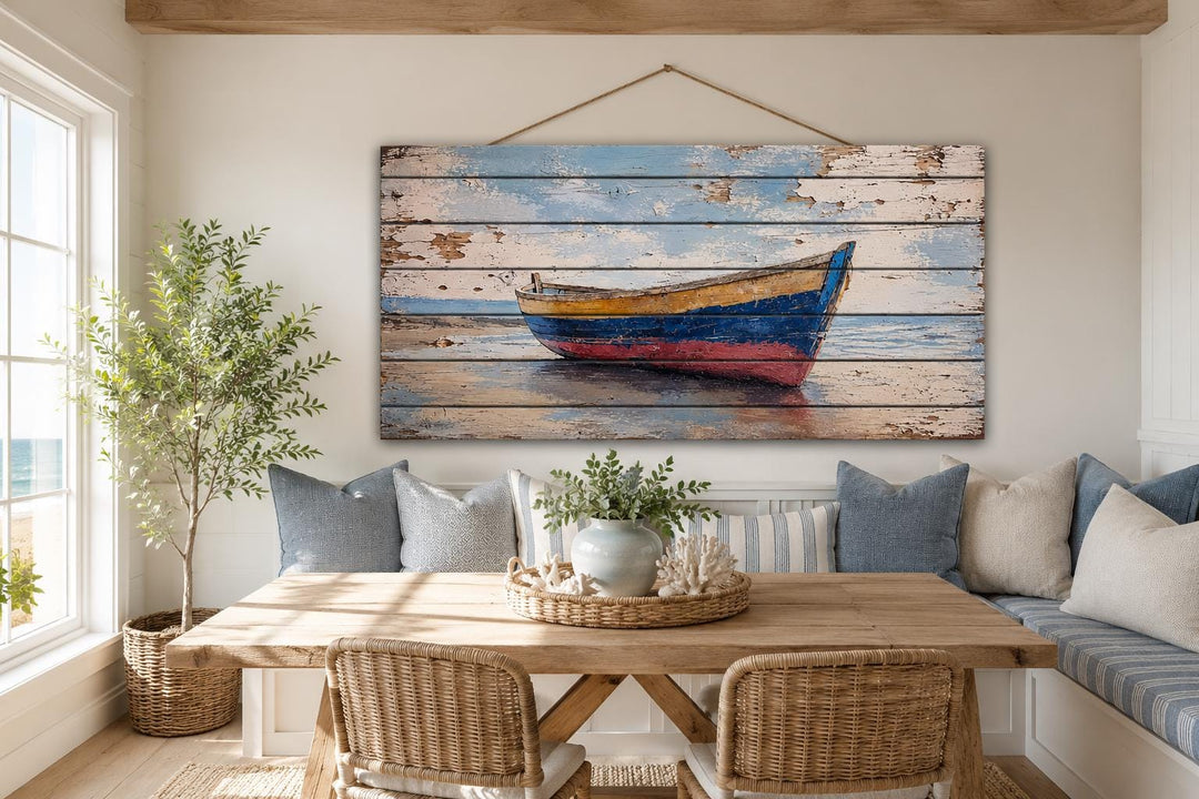 Old wooden rowboat on shore distressed wood wall art hanging in a coastal dining room.