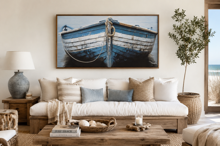 Rustic blue and white boat wall art above a white sofa in a coastal-style living room.