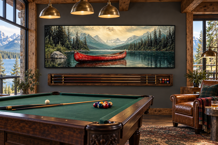 Rustic framed canvas wall art of an old red canoe on a mountain lake above a pool table.