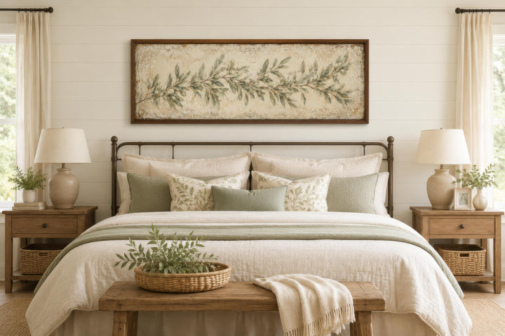 Long narrow olive branch canvas wall art in a sage green farmhouse bedroom above a metal bed frame.
