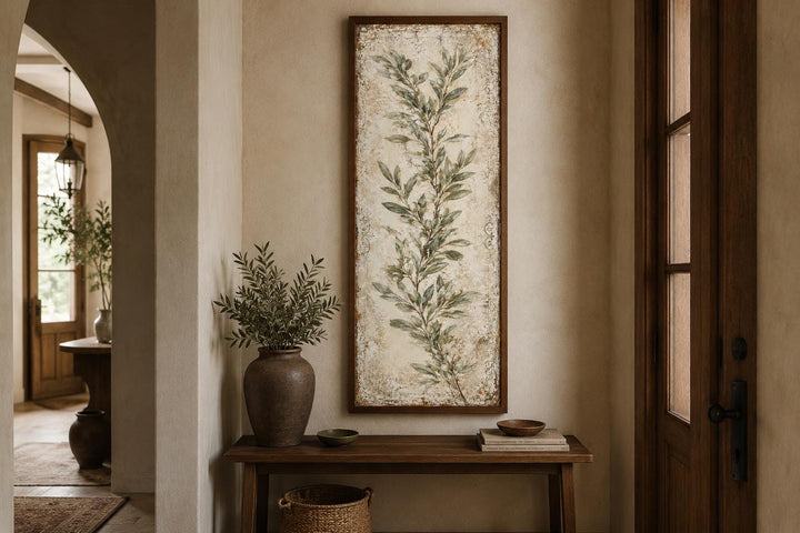 Tall vertical canvas wall art featuring a painted olive branch in a rustic wooden frame.