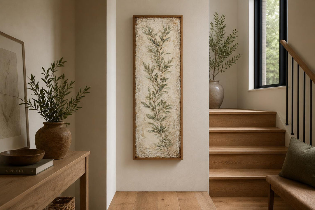 Tall vertical canvas wall art featuring a painted olive branch in a rustic wooden frame.