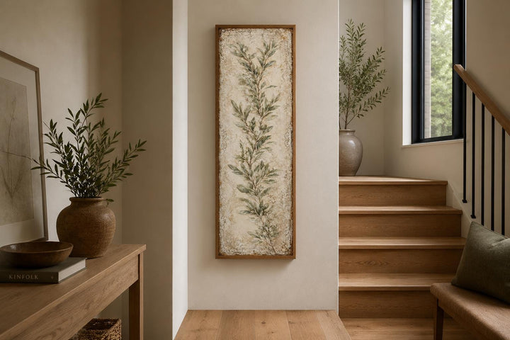 Tall vertical canvas wall art featuring a painted olive branch in a rustic wooden frame.