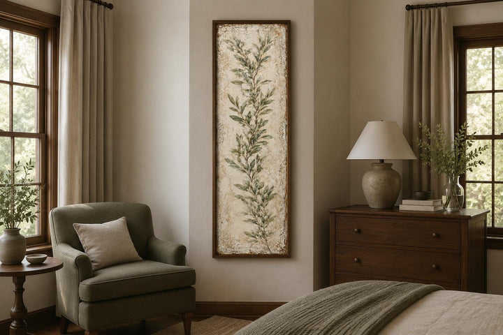 Tall vertical canvas wall art featuring a painted olive branch in a rustic wooden frame.