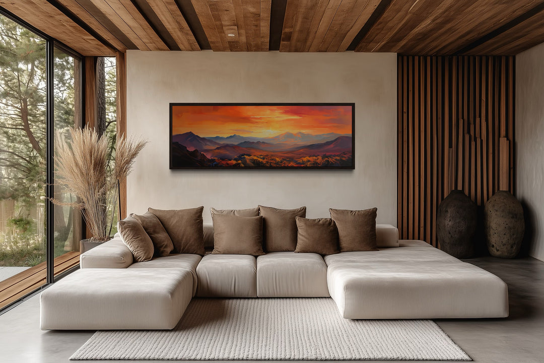 Orange mountain sunset horizontal framed canvas wall art hanging above a modern beige sectional sofa.