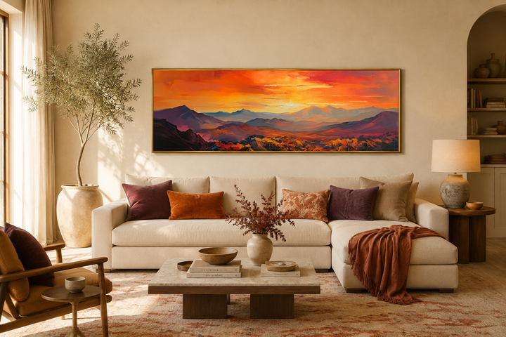 Orange mountain sunset horizontal framed canvas wall art hanging above a cream-colored sofa.