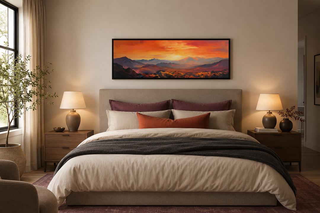 Orange mountain sunset horizontal framed canvas wall art hanging above a bed in a neutral bedroom.
