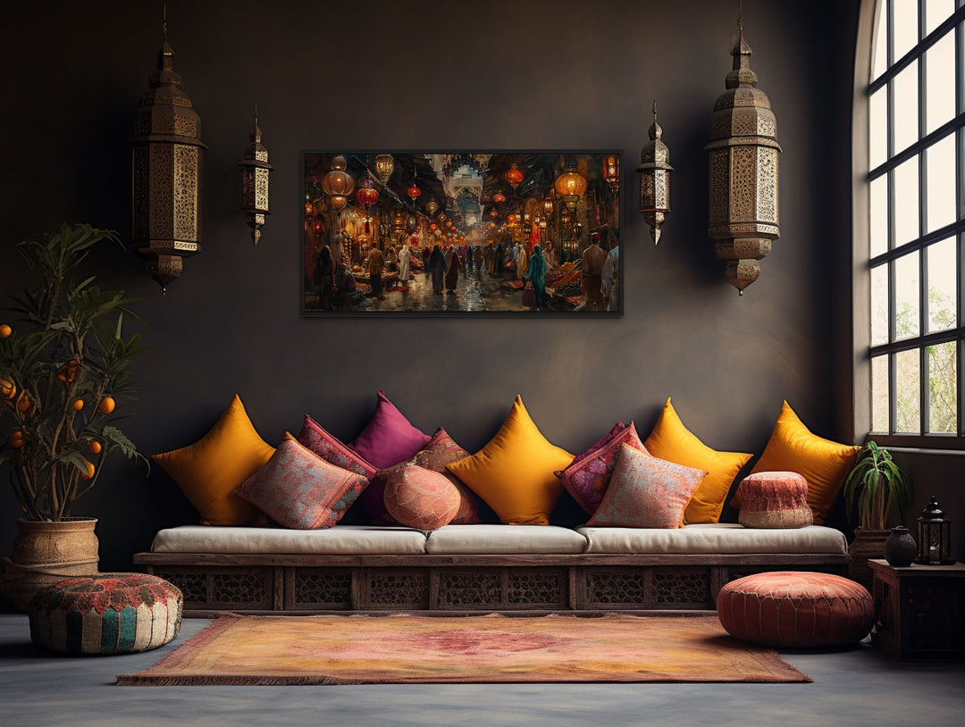 Framed canvas painting of a bustling oriental bazaar market hanging in a rustic living room.