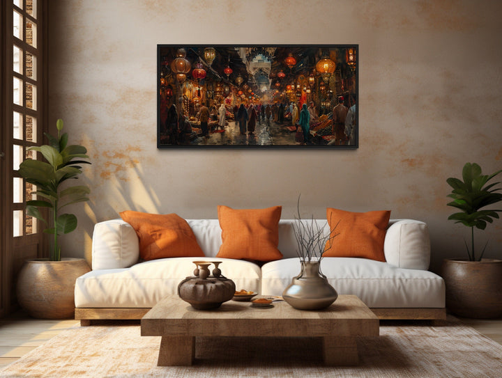 Oriental bazaar framed canvas wall art hanging above a white sofa in a rustic living room.