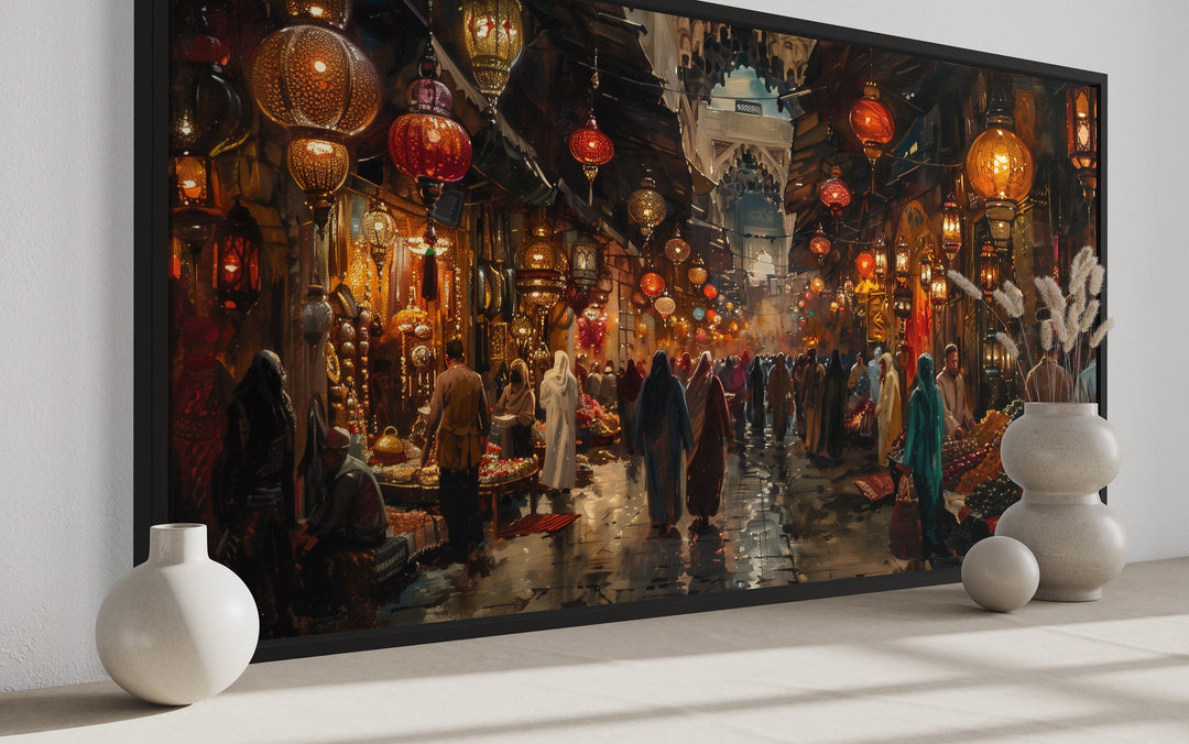 Framed canvas painting of a bustling oriental bazaar with glowing lanterns and market stalls.