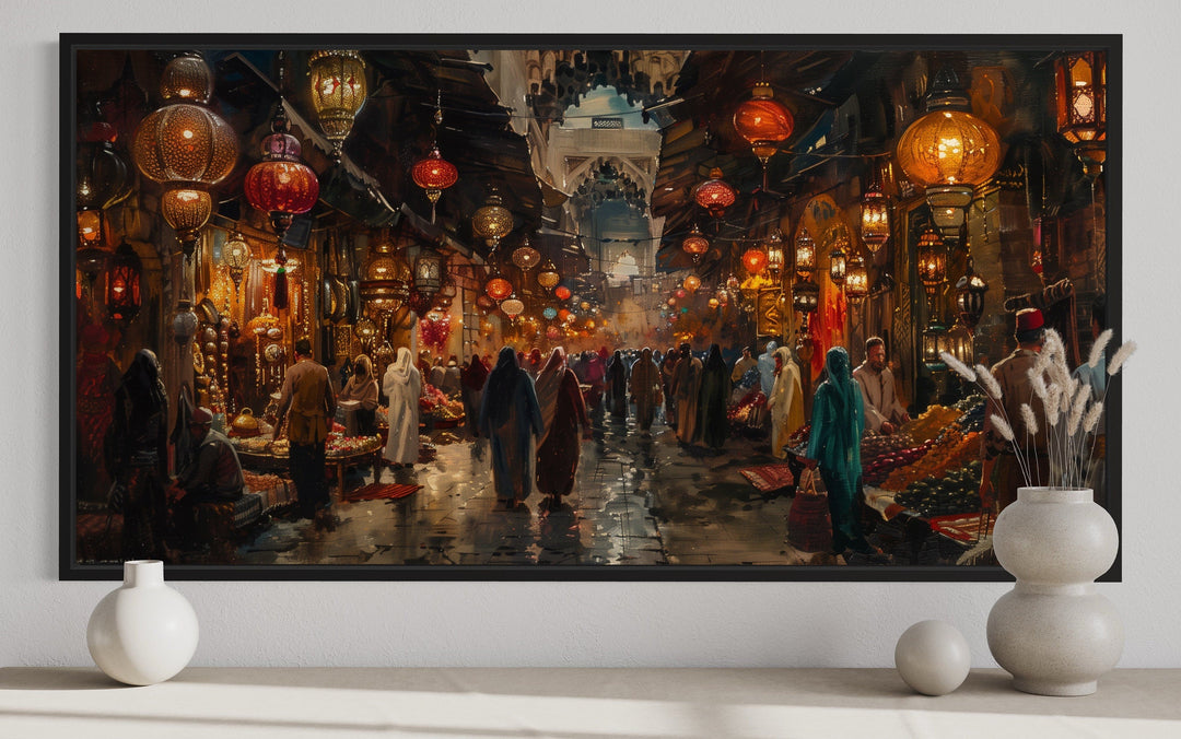 Framed canvas painting of a bustling oriental bazaar with glowing lanterns and market stalls.