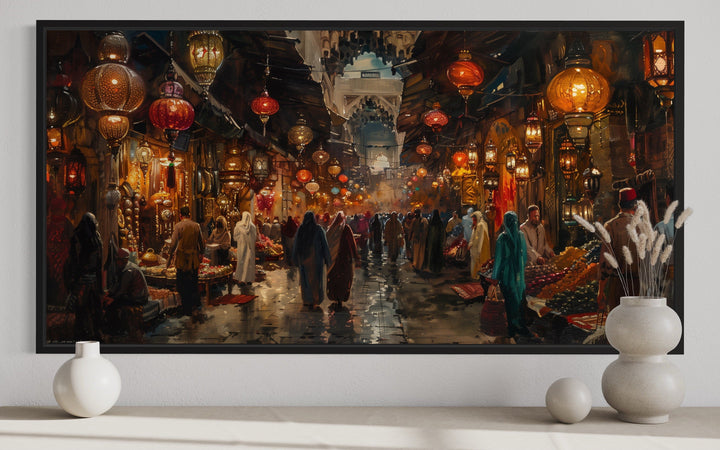 Framed canvas painting of a bustling oriental bazaar with glowing lanterns and market stalls.