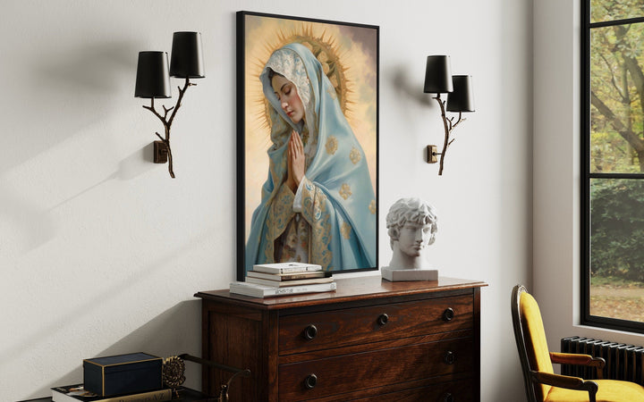 Our Lady of Guadalupe framed canvas wall art hanging above a wooden dresser in a Christian home.