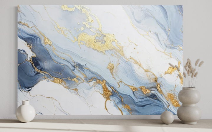 Pale blue, grey, and gold abstract marble canvas wall art displayed above a shelf with vases.