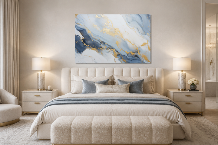 Abstract marble canvas wall art with pale blue, grey, and gold accents above a bed in a bedroom.