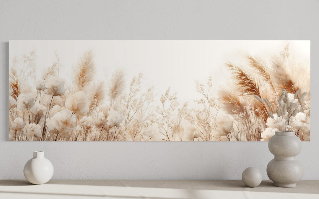 Long horizontal canvas wall art featuring neutral pampas grass and dried florals above a console.