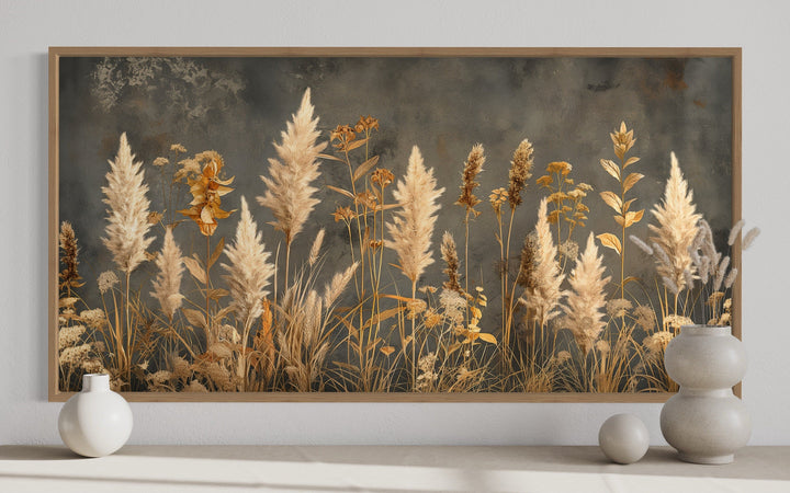 Framed canvas wall art of pampas grass and dried botanicals on a textured grey background.