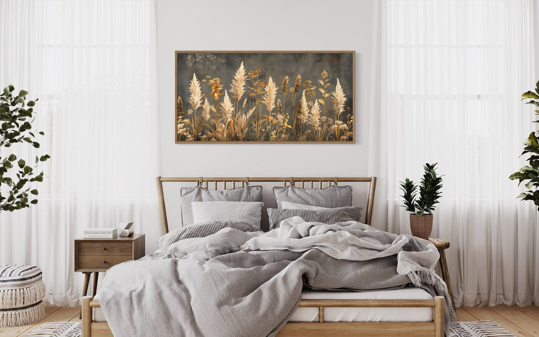 Pampas grass on grey background rustic neutral framed canvas wall art hanging above a bed.