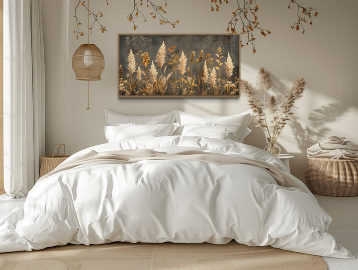 Pampas grass on grey background rustic neutral framed canvas wall art above a white bed.