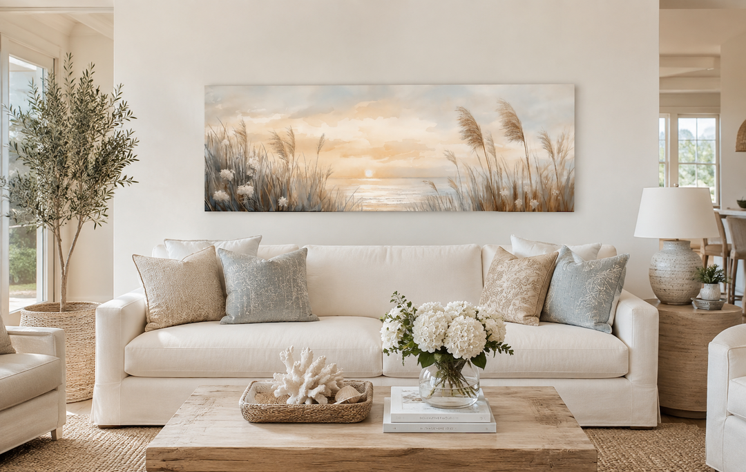 Pampas grass on the beach coastal horizontal wall art hanging above a white sofa in a living room.
