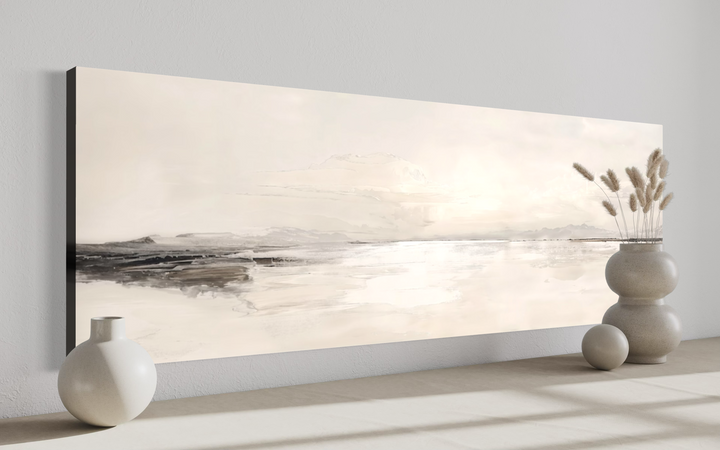 Panoramic neutral coastal landscape framed canvas wall art in a minimalist room setting.