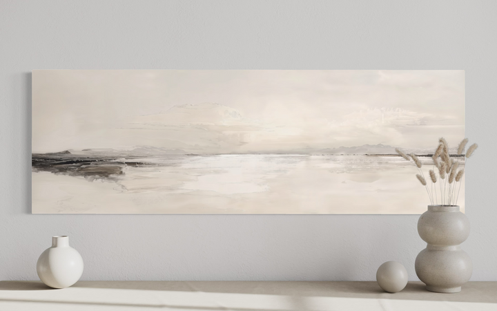 Panoramic neutral coastal landscape canvas wall art in a minimalist room setting.