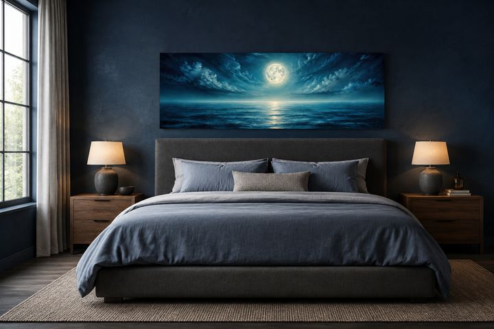 Panoramic navy blue ocean and moon in night sky wall art above a bed in a modern bedroom.