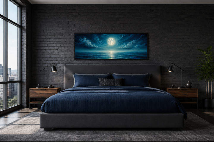 Panoramic navy blue ocean and moon wall art hanging above a bed in a dark brick bedroom.