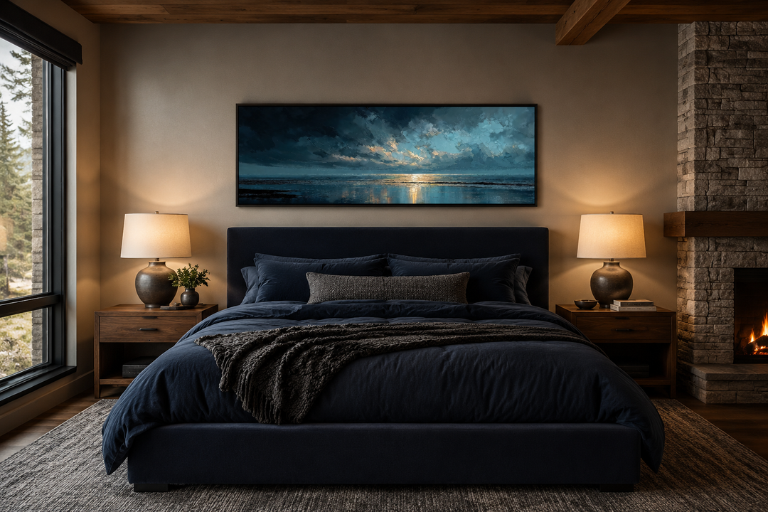 Panoramic ocean wall art with blue, grey, and gold sunset over a dark blue bed in a modern bedroom.