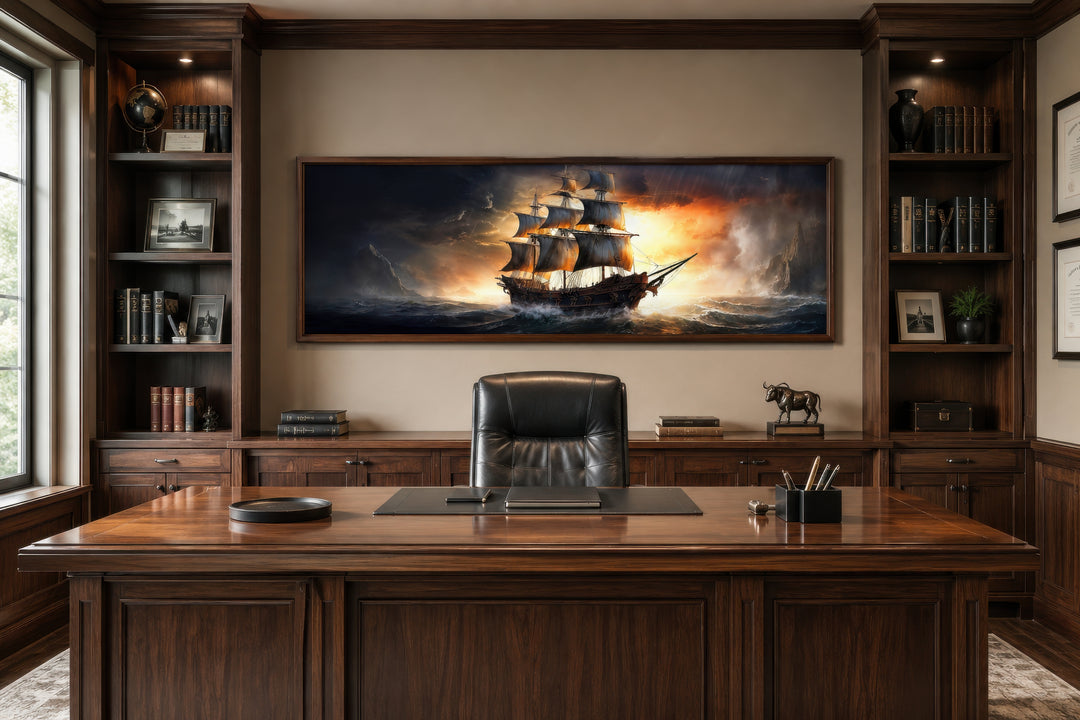 Panoramic framed canvas wall art of a pirate ship on a stormy ocean above a wooden office desk.