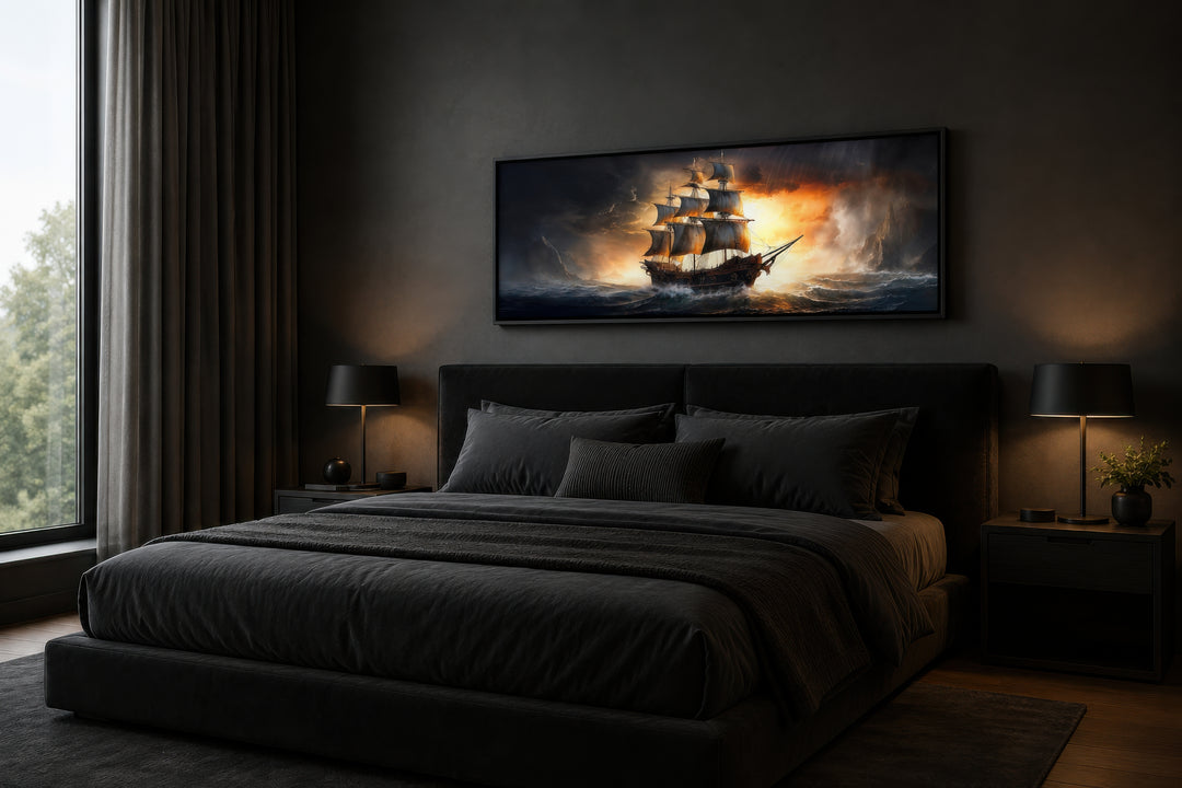 Panoramic framed canvas wall art of a pirate ship in a stormy ocean above a dark bedroom bed.