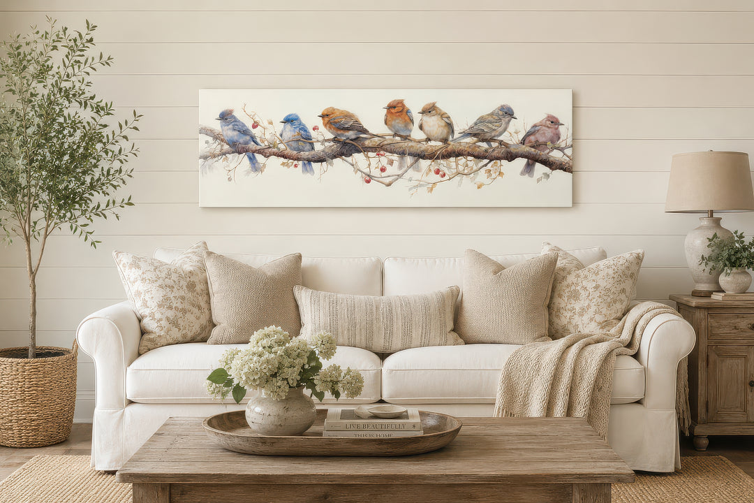 Horizontal framed canvas wall art featuring seven colorful birds perched on a branch.