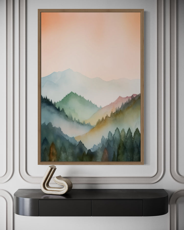 Vertical framed canvas wall art of a pastel mountain landscape in blush pink and green tones.