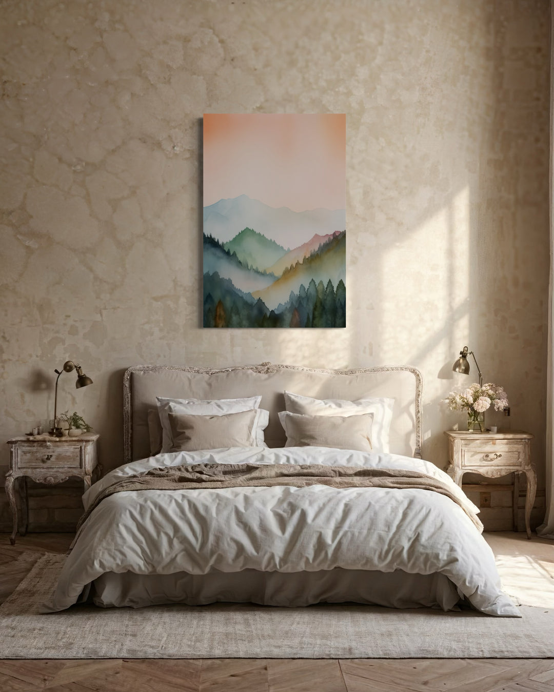 Vertical framed canvas wall art of a pastel mountain landscape in blush pink and green over a bed.