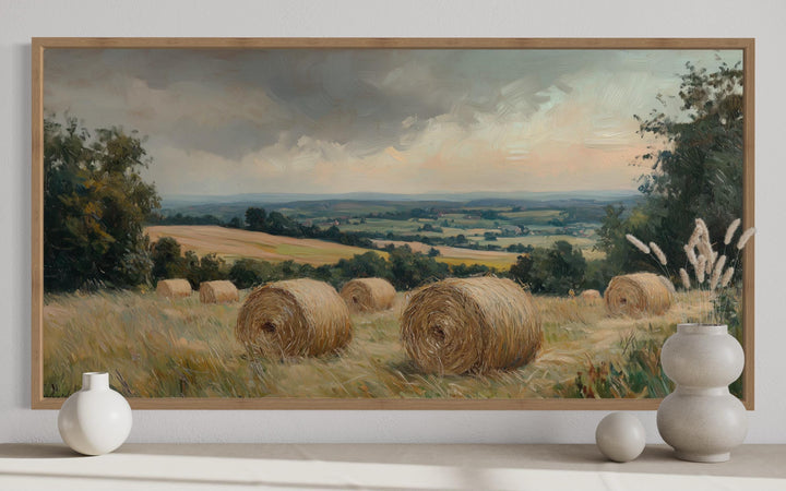 Pastoral hay field framed canvas wall art featuring round hay bales in a rural landscape.