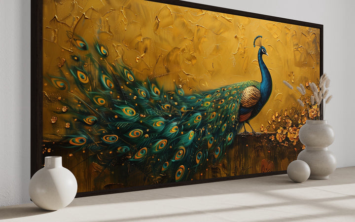 Framed peacock canvas print with vibrant blue and green feathers on a textured gold background.
