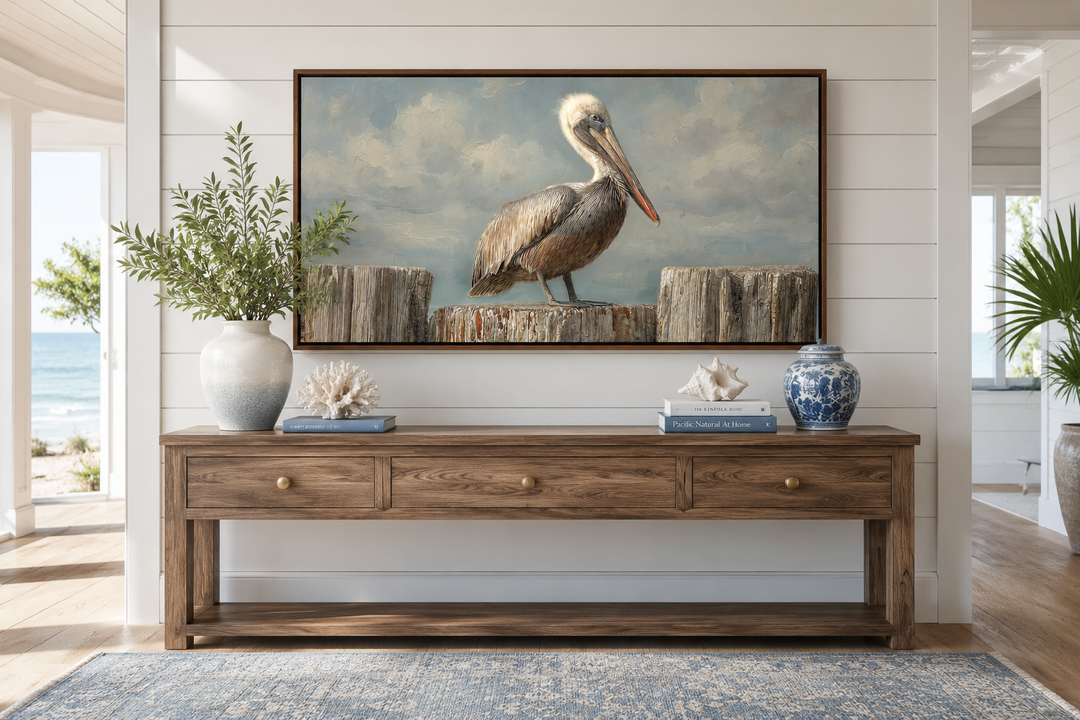Pelican Standing On Wooden Posts Coastal Canvas Wall Art above a wooden console table.