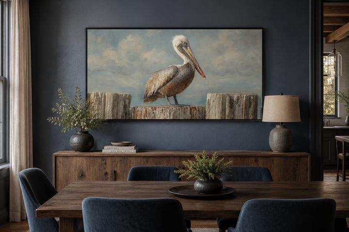 Pelican Standing On Wooden Posts Coastal Canvas Wall Art displayed above a wooden sideboard.