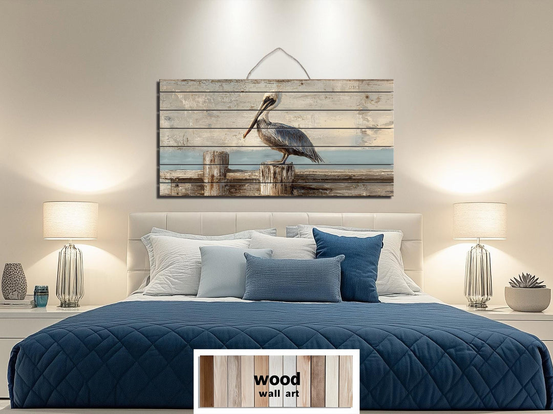 Coastal wall art featuring a pelican on a weathered dock printed on horizontal wood planks.