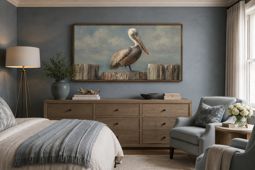Pelican Standing On Wooden Posts Coastal Canvas Wall Art above a dresser in a bedroom.