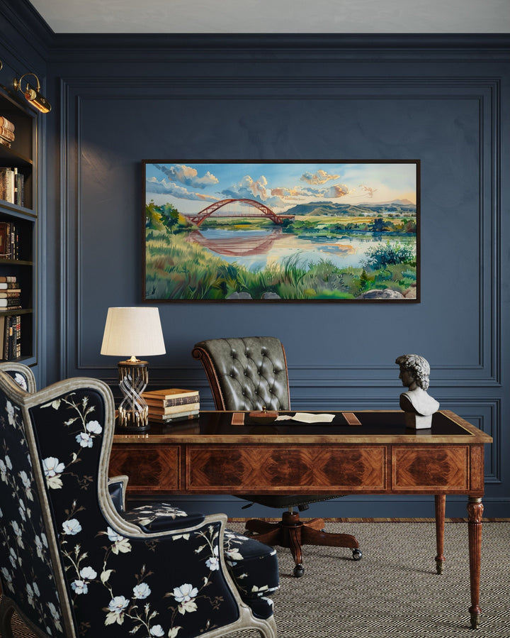 Watercolor painting of Pennybacker Bridge in Austin, Texas, framed on a dark blue office wall.