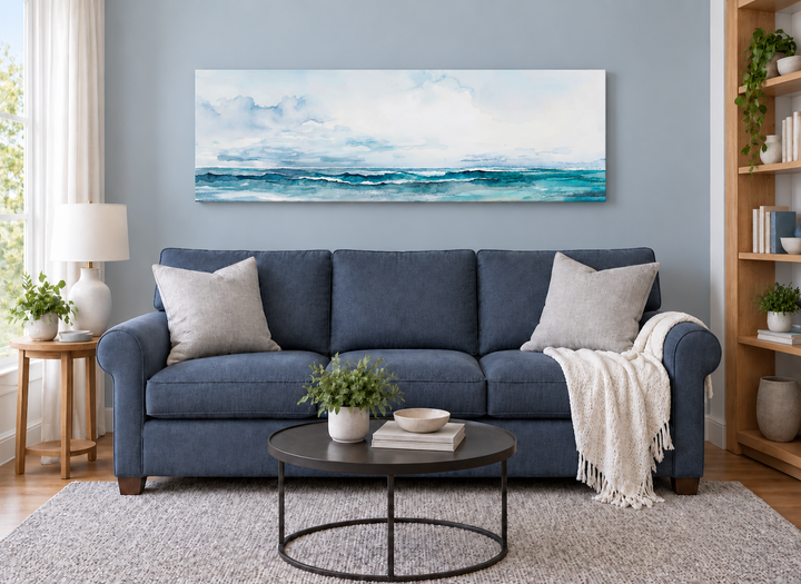Minimalist ocean blue and gray horizontal framed canvas wall art hanging over a blue sofa.