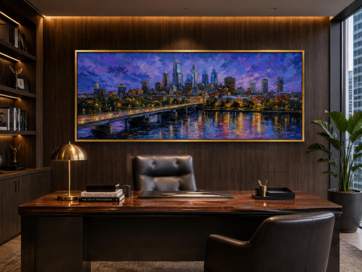 Philadelphia skyline wall art in a long horizontal canvas with a gold floating frame in an office.