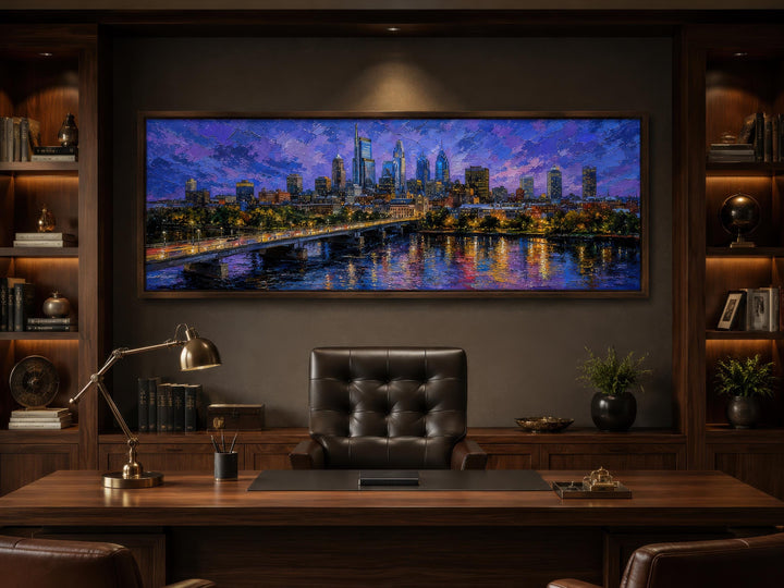 Philadelphia skyline wall art in a floating frame above a dark wood desk in a home office.